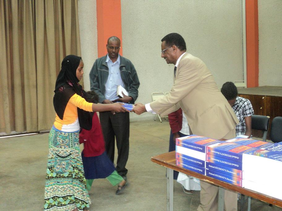Ato Getachew Tessema, Representative Of Kinderhaus Addis While Handing Over The Dictionary To The Sponsored Children